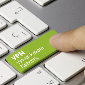 cyberghost vpn services hitting green vpn key on laptop